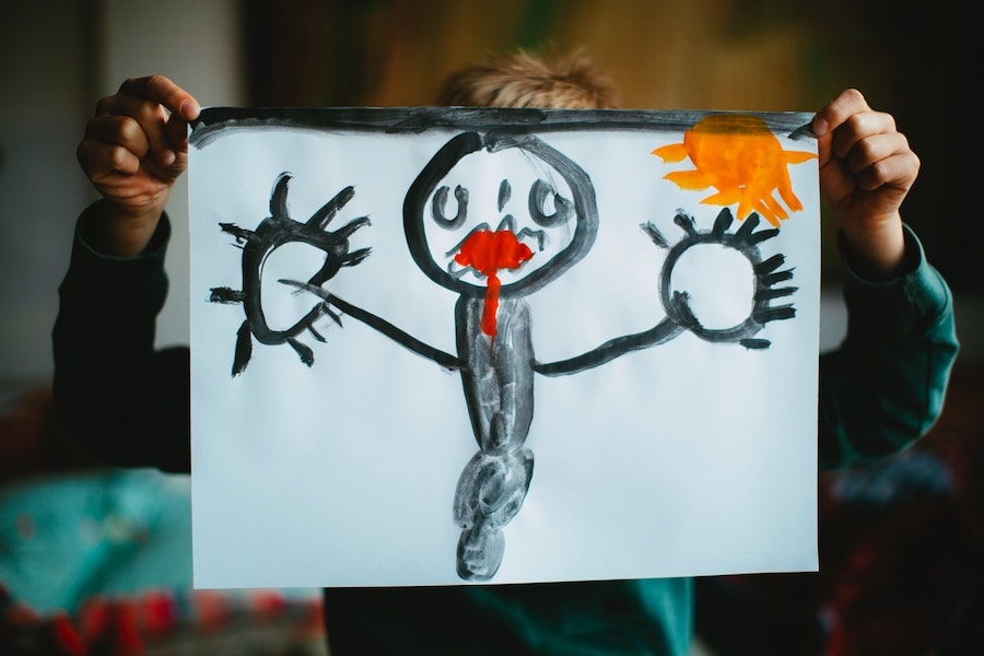 kid holding up a drawing